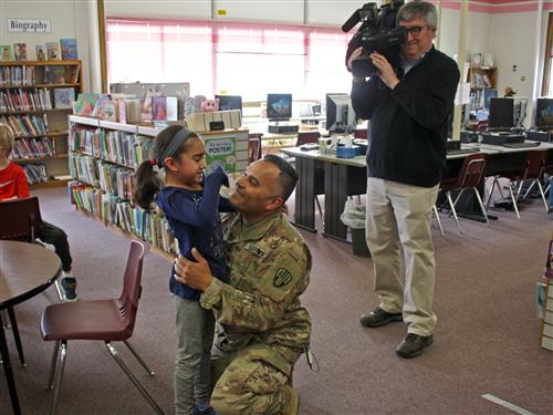 Soldier greets daughter in school library as WGRZ reporter films it 