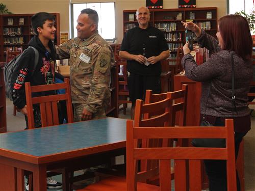 Solder greets son in school library 