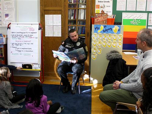 Police officer reading to class 