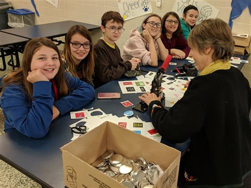 Students making buttons 
