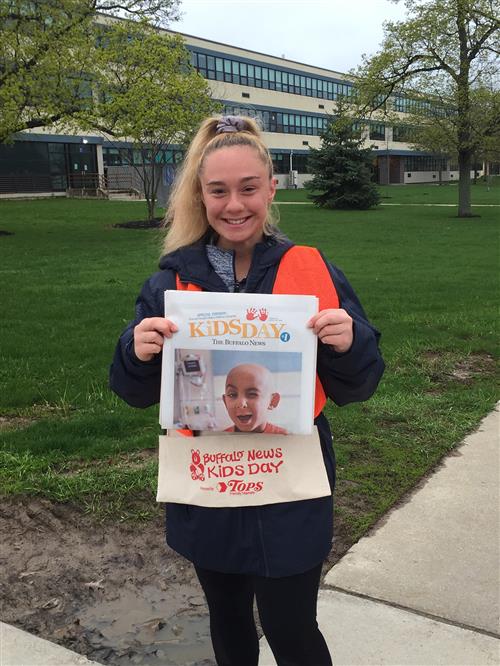 Student holding newspaper 
