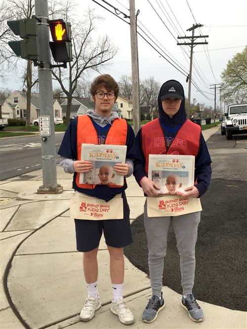 Students holding newspaper 