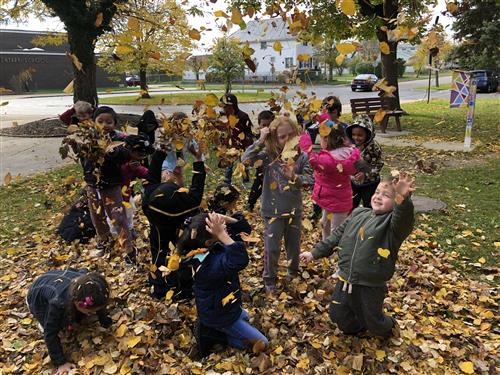 Students playing in leaves 