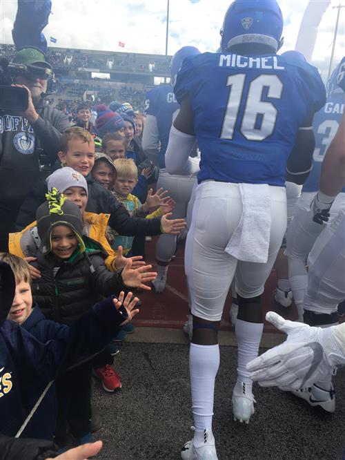 Students give players high-fives 