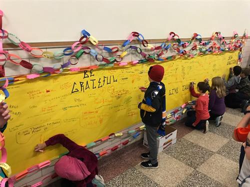 Franklin Elementary student writes on graffiti wall 