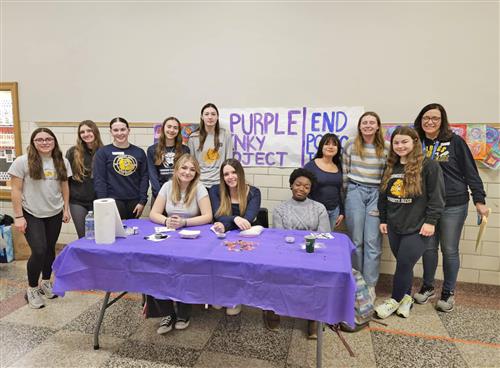 students pose with their purple pinky project sign