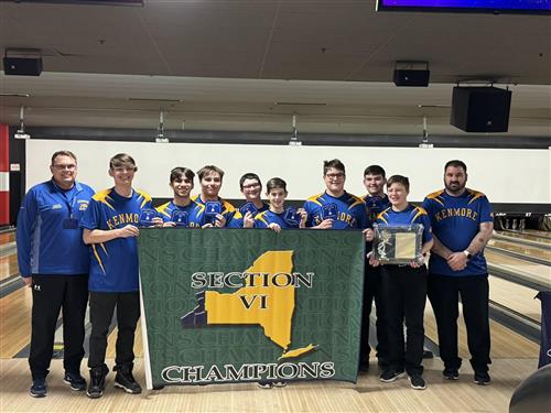 boys bowling team poses with their championship banner