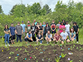  students pose in front of a garden