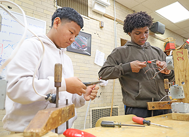  two students work on an engineering project