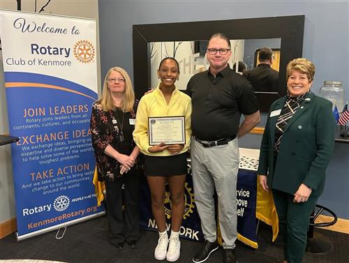 Ken East student poses with assistant principal and others with a scholarship award