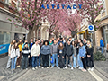  students pose by a cherry tree in Germany