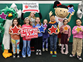  Students post with Independent Health and Hoover Elementary mascot in new Independent Health Fitlab