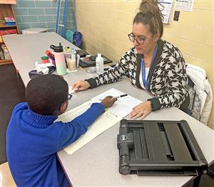 Teacher works with visually impaired student