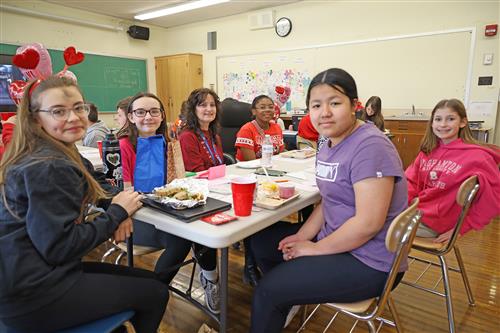 students enjoy a pizza party for being a top reader