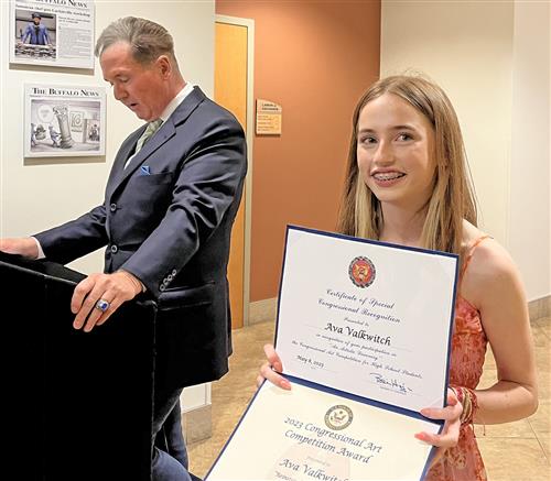 Kenmore East student Ava Valkwitch holds up her contest-winning certificate