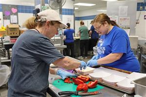 staff members chop vegetables