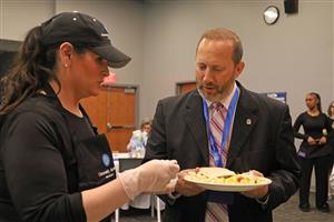 Superintendent Sabatino Cimato gets toppings for his pasta dish