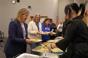 Students serve lunch to district administrators