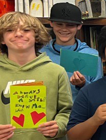 Students holding cards