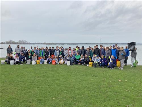 Volunteers pose in front of the water on the Niagara Shoreline Trail