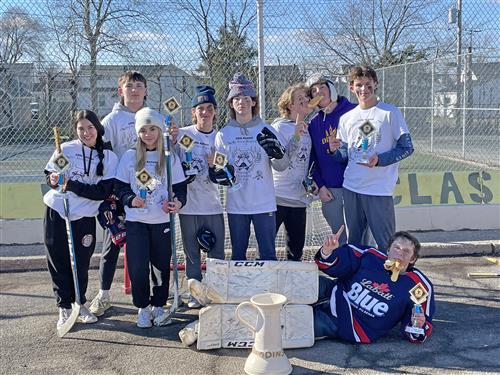 Kenmore East students post with a trophy after winning a street hockey tournament