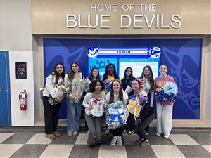 students pose with homemade blankets