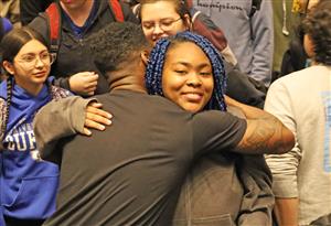 Ken Nwadike Jr. hugs Kenmore West student after assembly