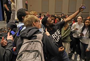 Ken Nwadike Jr. takes a selfie with Kenmore West students