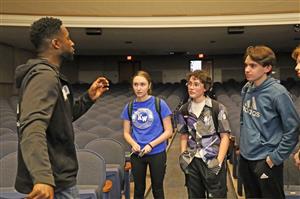 Ken Nwadike Jr. speaks with students after assembly