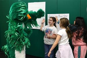 Students high five the Hoover Elementary mascot
