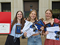  Three senior girls pose with awards in front of high school