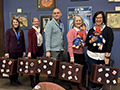  Librarians pose with suitcases and Paddington Bears