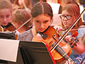  girl plays the violin during a concert
