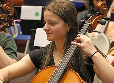  high schooler plays an instrument at a dress rehearsal