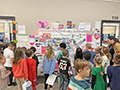  students look at a map of the US for a valentines day exchange project