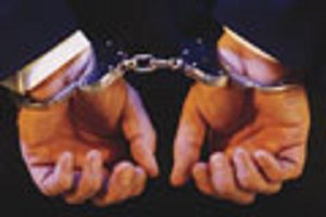 In hand cuffs.